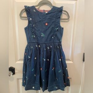 Denim dress with embroidered flowers and ruffle trim. Boden 11-12
